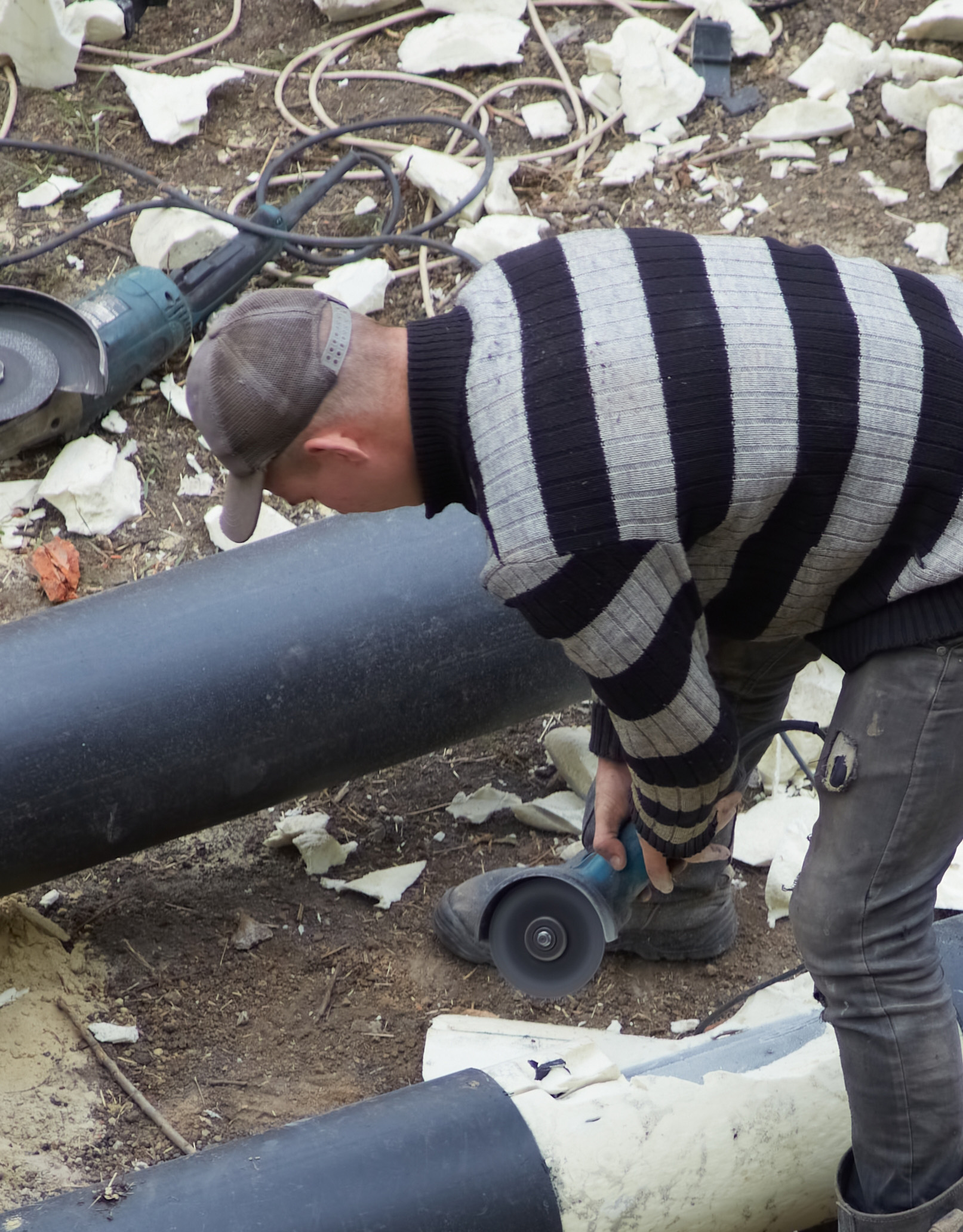 Photo of Worker Removing hard conventional insulation for MRO - destroys insulation