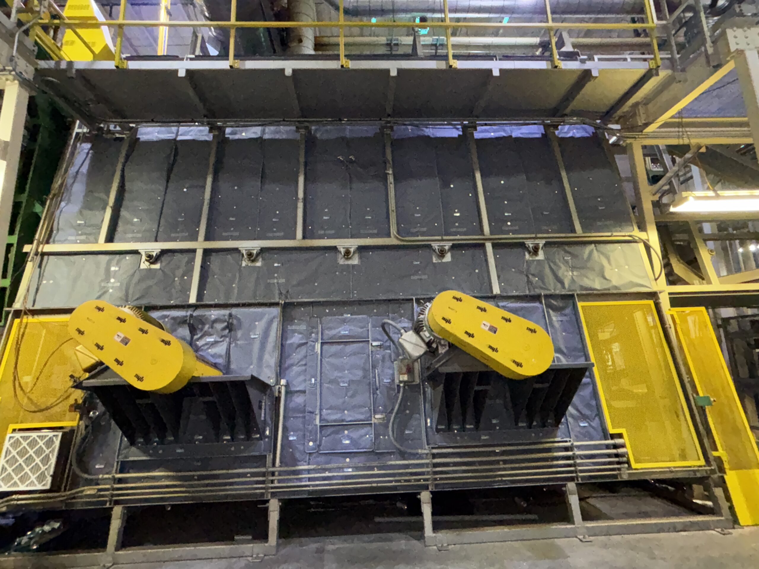 Photo of Project Highlight- Beverage Can Manufacturing - Pin Oven showing Shannon's expert fit around the complicated geometry of protruding elements. Shannon Global Energy Removable reusable Insulation Blankets for Processing equipment in Food & Beverage industry.